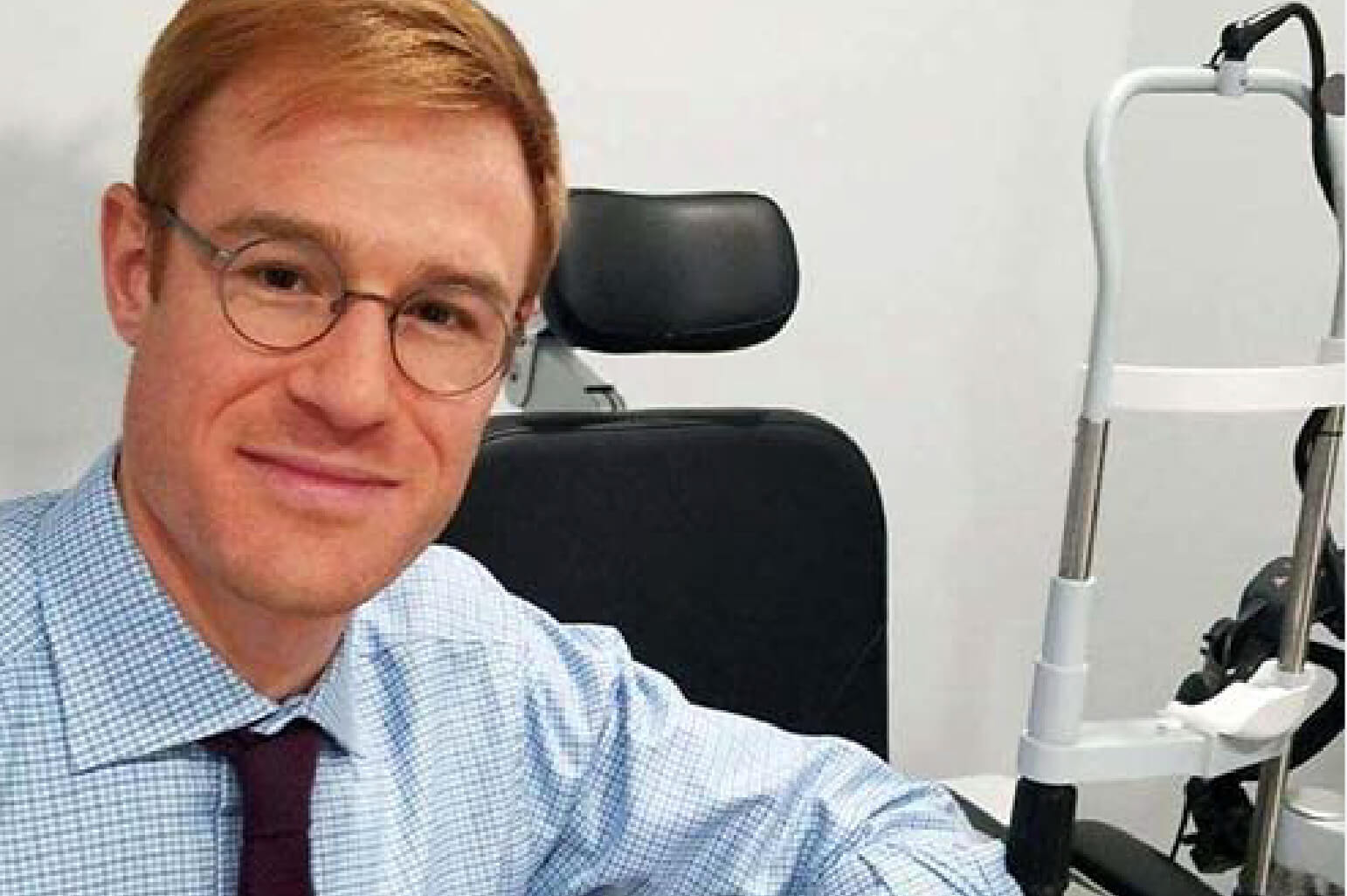 standard-optical-doctor One of Standard Optical's doctor is smiling in an office.
