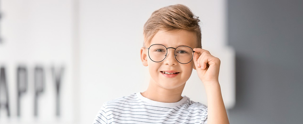 Child happy with his glasses at standard optical