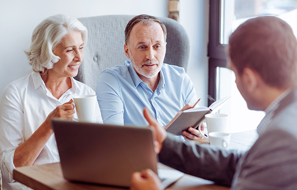 Mature couple engaging with doctor over his laptop