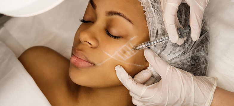 doctor administering botox to woman