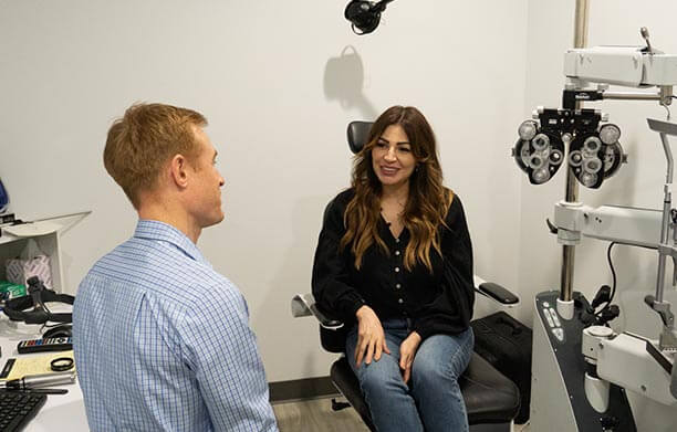 Doctor facing patient providing consultation for an eye exam.