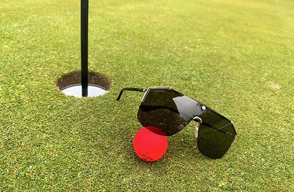 golf ball and Gucci sunglasses