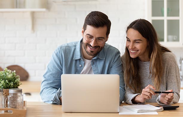 couple is happy using laptop